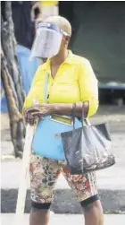  ?? (Photo: Garfield Robinson) ?? In this August 24, 2020 file photo a woman, seen in downtown Kingston, wears a face shield as she is taking no chances given the COVID-19 outbreak in the island. The face shield, however, is to be worn with a mask to be effective.