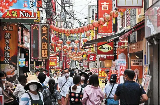  ?? — AFP ?? Brisk business: People walking down a busy street in Yokohama’s Chinatown. Inflation in Japan hit 2.8% in August, the highest level since 2014 and it comes as the BOJ tries to underpin a fragile economy by maintainin­g ultra-low interest rates.