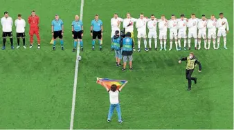  ??  ?? Protester…one fan took a rainbow flag onto the pitch ahead of Germany’s clash v Hungary