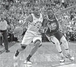  ??  ?? Raptors forward Kawhi Leonard is fouled by Warriors forward Draymond Green during Game 5 of the NBA Finals on Monday in Toronto.