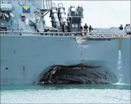  ??  ?? The Associated Press Damage to the portside is visible as the guided-missile destroyer USS John S. Mccain steers Monday toward Changi naval base in Singapore following a collision with the merchant vessel Alnic MC.