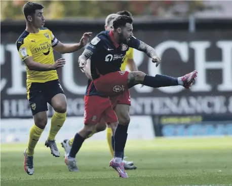  ??  ?? Chris Maguire in action against Oxford United at the Kassam Stadium.