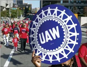  ?? ASSOCIATED PRESS FILE PHOTO ?? United Auto Workers members walk in the Labor Day parade in Detroit, Sept. 2, 2019.