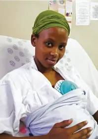  ??  ?? Above: Zinhle, 29, holds her son, Ayandiswa, two weeks old, wrapped against the warmth of her body in the Kangaroo Mother Care unit in the Prince Mshiyeni Memorial Hospital in Durban.