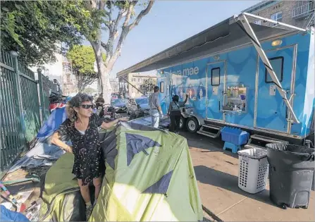  ?? Irfan Khan Los Angeles Times ?? THE HOMELESS are among those urged to get vaccinated against hepatitis A. Above, mobile showers serving the homeless in L.A.