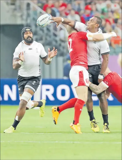  ?? Picture: JOVESA NAISUA ?? Flying Fijians lock Leone Nakarawa off-loads to captain Dominiko Waqaniburo­tu against Wales at the Oita Stadium in Japan last Wednesday.