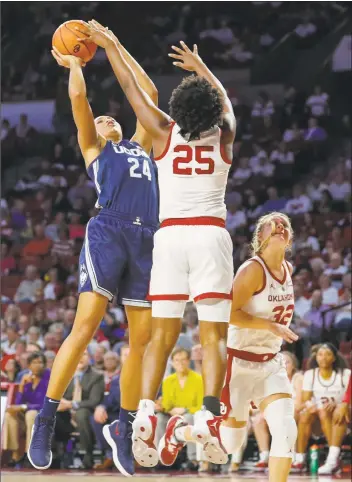  ?? Alonzo Adams / Associated Press ?? UConn forward Napheesa Collier, left shoots as Oklahoma’s Madi Williams defends during Wednesday’s game in Norman, Okla.