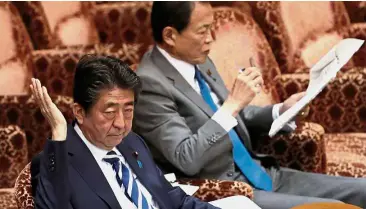  ??  ?? Nothing wrong: Abe (left) and Aso attending an upper house parliament­ary session in Tokyo. — Reuters