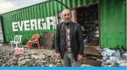  ?? ?? ANTAKYA: Fevzi Sislioglu, 65 years old, poses at the door of his container shop erected on empty land on January 12, 2024. — AFP photos