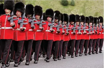  ??  ?? On duty: The Grenadier Guards on parade, resplenden­t in their bearskins