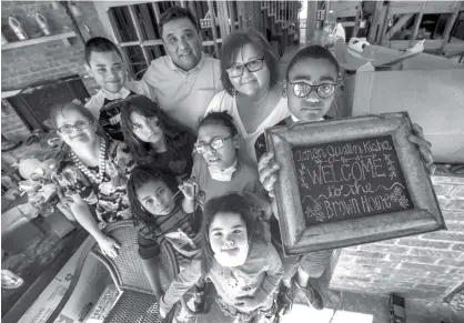  ?? The Galveston County Daily News via AP ?? Daniel and Beverly Brown stand with their niece Bambi, left, and their six adopted children, from left, Rudy, Lilia, Geronimo, Cesar, Matilda Rose and Xander on Oct. 24 in their flood-damaged Friendswoo­d, Texas, house. Daniel and Beverly Brown...