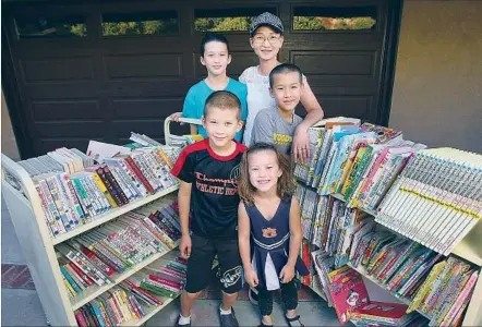  ?? Tim Berger Glendale News Press ?? MITSUKO ROBERTS, with her children Minami, 11, Ray, 13, Luke, 9, and Akemi, 6, opened Okanoue Library in her home in May 2015. She says the library is a way to provide more access to students to expand familiarit­y with speaking, reading and writing in Japanese.