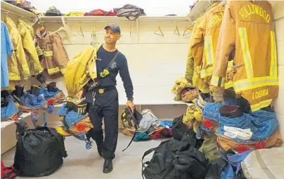  ?? JOE CAVARETTA/STAFF PHOTOGRAPH­ER ?? David Civita, Hollywood Fire and Rescue 2016 Firefighte­r of the Year, grabs his bunker gear to start his 24-hour shift Thursday at Fire Rescue Station 74. Civita was honored for his dedication and service to the fire department and the citizens of...