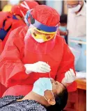  ??  ?? THE OGRE RETURNS WITH A VENGENCE: COVID’s second wave strikes as fears grow whether it has entered the community or is still contained in cluster. Picture shows a person undergoing a PCR test.