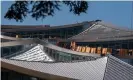  ?? Bloomberg/Getty Images ?? Workers constructi­ng the ‘solar skin’ roof in Mountain View, California. Photograph: