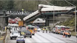  ?? STEPHEN BRASHEAR — GETTY IMAGES ?? Rescuers work at the scene of a derailment in DuPont, Washington, that left at least 3 dead.