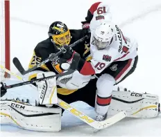  ?? THE CANADIAN PRESS FILES ?? Ottawa’s Derick Brassard collides with Pittsburgh goalie Marc-Andre Fleury for a goaltender interferen­ce penalty earlier this season.