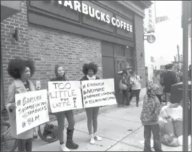  ?? AP Photo/Ron Todt, File ?? Protesting: In this April 15, 2018, file photo, demonstrat­ors protest outside the Starbucks cafe in Philadelph­ia where two black men were arrested three days earlier for waiting inside without ordering anything. On Tuesday, the company plans to close...