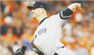  ?? BOB LEVEY/GETTY IMAGES ?? Former Jays pitcher J.A. Happ of the New York Yankees throws in relief Sunday night in Houston, where he gave up the winning run in the bottom of the 11th inning.