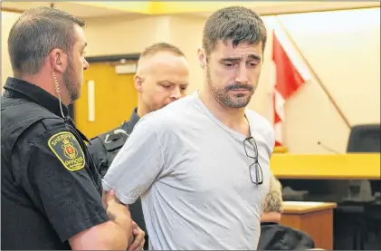  ?? TARA BRADBURY/THE TELEGRAM ?? Sherrif’s officers place handcuffs on Grant Tapper, 33, as they prepare to escort him back to the holding cells during a break in his sentencing hearing at provincial court in St. John’s Wednesday. Tapper was sentenced to nine months behind bars for...