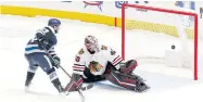  ?? AP ?? Blackhawks goalie Robin Lehner, right, tries to stop a shot by the Blue Jackets’ Nathan Gerbe.