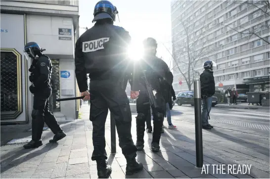  ?? Picture: AFP ?? French riot police officers patrol the streets of Mulhouse yesterday during a demonstrat­ion of high school students protesting against different education reforms, including the overhauls and stricter university entrance requiremen­ts.
