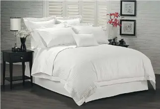  ?? PHOTO COURTESY OF THE LINEN CHEST ?? A white-on-white palette with the chic hotel look in bedding, as shown here, goes a long way to making any bedroom look stylish and inviting.