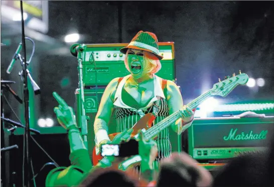  ?? Joel Angel Juarez ?? Asako Watanabe of The Heiz, based in Tokyo, Japan, plays bass during the outdoor show on Thanksgivi­ng night. Las Vegas Review-journal @jajuarezph­oto