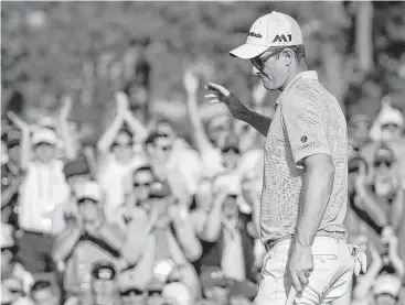  ?? Matt Slocum / Associated Press ?? England’s Justin Rose, the gold medalist in the 2016 Summer Olympics, sinks a birdie putt on the 18th hole to cap his back-nine charge to the top of the third-round leader board at the Masters on Saturday.