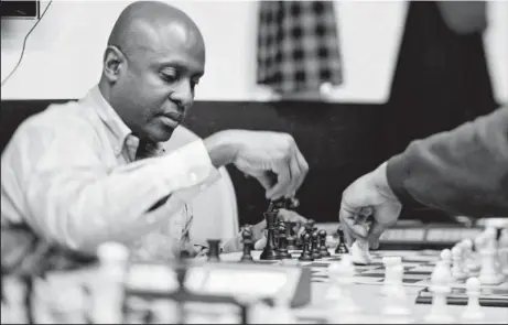  ??  ?? Jerald Times, a school teacher from Harlem, teaches underprivi­leged children the game of chess. Times was a champion of Harlem at 14, and is considered one of the five strongest black players in the world. He honed his skills in chess by playing...