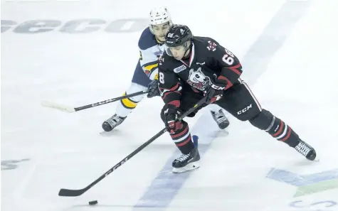  ?? JULIE JOCSAK/ STANDARD STAFF ?? Billy Constantin­ou of the Niagara IceDogs battles Kyle Maksimovic­h of the Erie Otters for the puck in OHL action at Meridian Centre in St. Catharines on Thursday.
