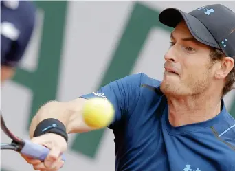  ??  ?? Britain's Andy Murray plays a shot against Russia's Andrey Kuznetsov during their first round match of the French Open tennis tournament at the Roland Garros stadium in Paris Tuesday. (AP)