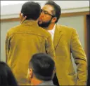  ?? Chase Stevens ?? Las Vegas Review-journal Arturo Martinez, whose wife and daughter were killed, embraces son Cristopher after testifying Thursday.