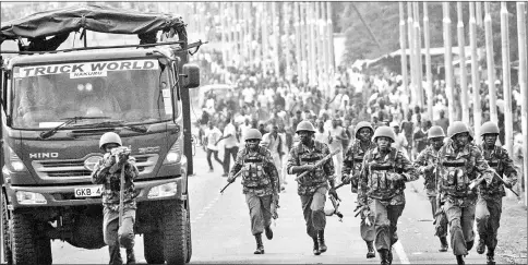  ??  ?? Police officers start to run as National Super Alliance (Nasa) supporters chase after them during a protest against Kenya’s second poll in Kisumu.