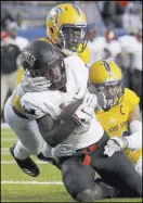  ?? Jeff Chiu The Associated Press ?? WR Tyleek Collins, being tackled by Dakari Monroe, right, and Jonathan Lenard Jr., had nine catches — four for touchdowns.