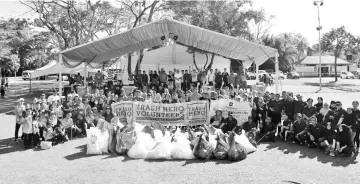  ??  ?? The 200 volunteers with the trash collected on the first day of the Tanjung Aru Beach Festival yesterday.