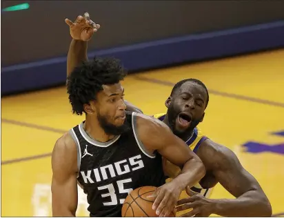  ?? EZRA SHAW — GETTY IMAGES ?? The Warriors’ Draymond Green draws an offensive foul on the Kings’ Marvin Bagley III at Chase Center in San Francisco on Monday.