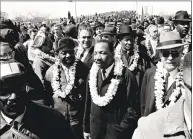  ?? Associated Press ?? The Rev. Martin Luther King Jr. and marchers cross the Edmund Pettus Bridge in Selma, Ala., in 1965.