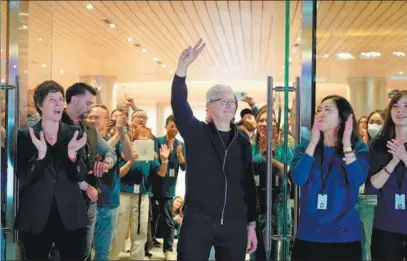  ?? GAO ERQIANG / CHINA DAILY ?? Apple CEO Tim Cook greets customers at the company’s newest store in Shanghai in March.