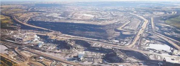  ?? JEFF MCINTOSH / THE CANADIAN PRESS FILES ?? A tarsands mine near Fort McMurray in 2011. A new wave of cold water is about to hit Canada's much-buffeted oilsands industry — with undetermin­ed consequenc­es.