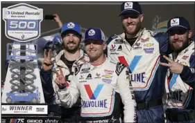  ?? (AP/Darryl Webb) ?? William Byron (center) poses with team members after winning the NASCAR Cup Series race Sunday at Phoenix Raceway in Avondale, Ariz. Byron has won two consecutiv­e races having also won at Las Vegas on March 5.