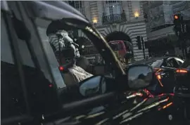  ?? Bernat Armangue Associated Press ?? A TRIBUTE to Queen Elizabeth II, the only monarch most Britons alive today have known, is reflected on a taxi at Piccadilly Circus in London on Friday.