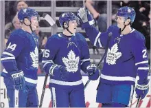 ?? FRANK GUNN THE CANADIAN PRESS ?? Mitch Marner celebrates a goal with Morgan Rielly and Ron Hainsey.
The three are among the Maple Leafs who have played at least 70 games this season.