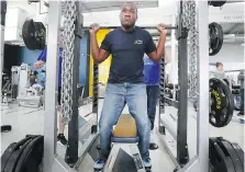  ??  ?? Joshua Palmer lifts weights during a workout at the St. Denis Centre as part of the Fit Together program.