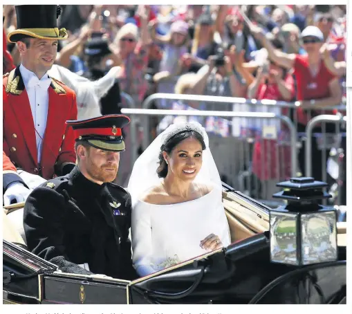  ?? Photo: Jeff J Mitchell/AP ?? Meghan Markle looks radiant as she rides in a carriage with her new husband Prince Harry.
