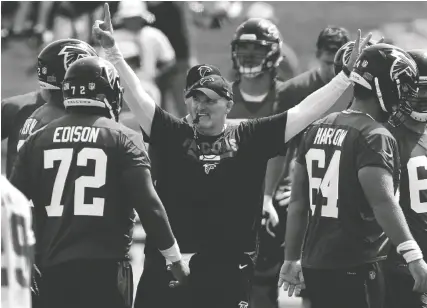  ?? THE ASSOCIATED PRESS ?? Atlanta Falcons head coach Dan Quinn keeps the team moving during training camp on Thursday in Flowery Branch, Ga.