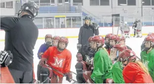  ?? JASON MALLOY/THE GUARDIAN ?? Members of The Mount Academy Saints’ under-18 girls’ hockey team watch as coach Kenny MacDougall explains a drill during practice Monday at Cody Banks Arena in Charlottet­own.
