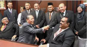  ??  ?? One big happy family: Aminuddin (seated centre) congratula­ting the Pakatan appointed coordinato­rs for state constituen­cies during the event in Seremban.