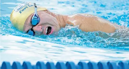  ?? SENTINEL PHOTO AMY BETH BENNETT/SOUTH FLORIDA SUN ?? Paralympic athlete Abbas Karimi swims across the pool at Riverland Park Pool in Fort Lauderdale on Tuesday.