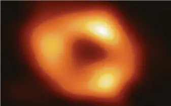  ?? Event Horizon Telescope Collaborat­ion ?? This image — made by eight synchroniz­ed radio telescopes around the world — shows a black hole at the center of our Milky Way galaxy. It is 4 million times more massive than our sun.